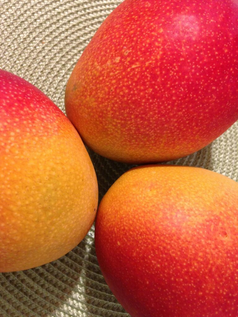 Close-up shot of vibrant, ripe mangoes showcasing their colorful texture and fresh appeal.