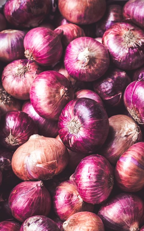 red onion on brown wooden table