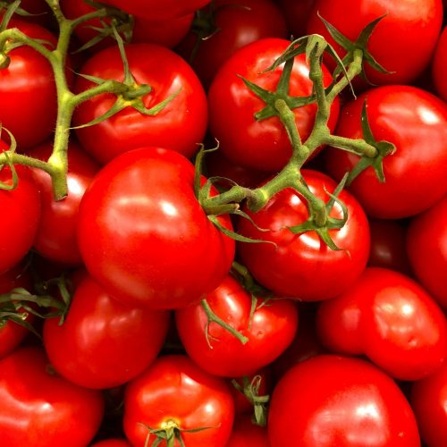 Vibrant close-up of fresh cherry tomatoes, showcasing their juiciness and bright red color.