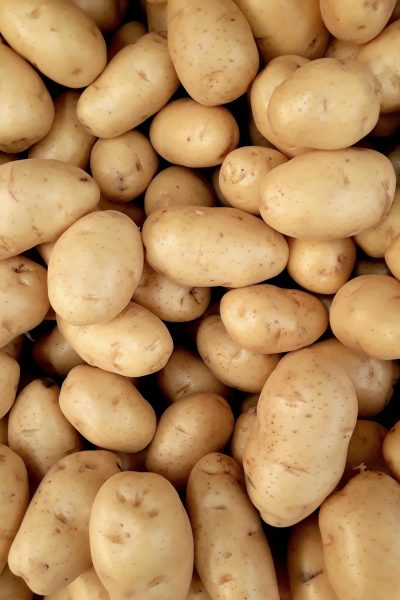 A close-up view of fresh organic potatoes piled together, showcasing natural texture and freshness.