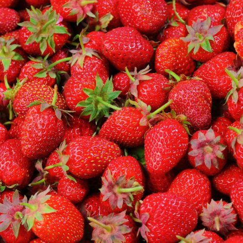 Vibrant close-up of fresh, organic, juicy strawberries displaying rich textures.